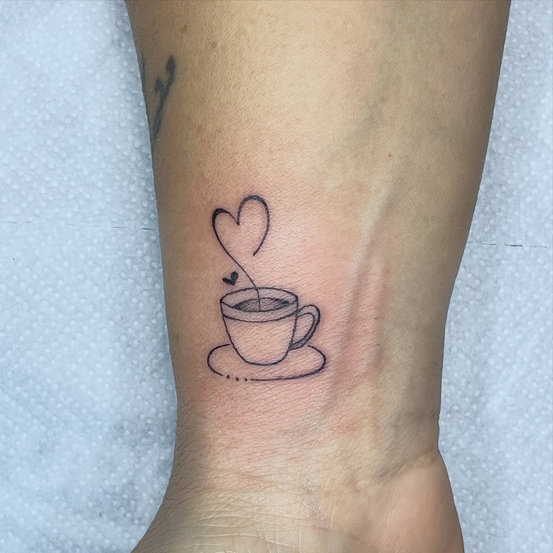 Charming minimalist coffee cup tattoo design