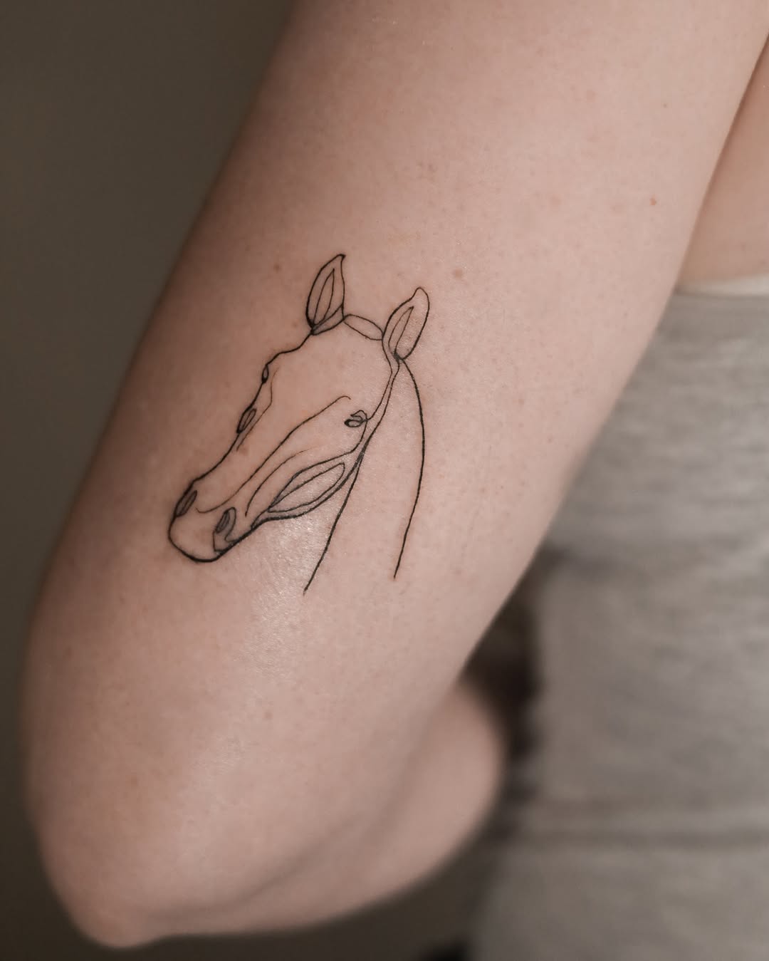 Elegant Minimalist Horse Tattoo in Line Art