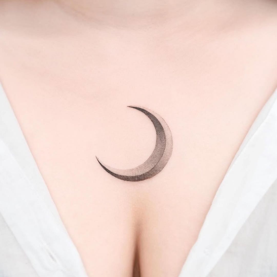 Elegant minimalist moon tattoo on the chest