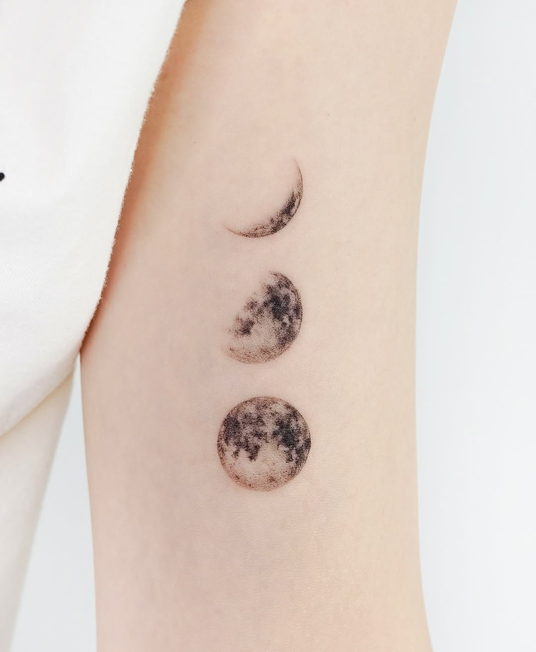 Stylish minimalist moon phases tattoo design