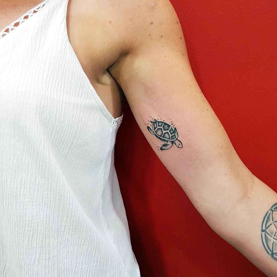 Charming minimalist turtle tattoo on arm