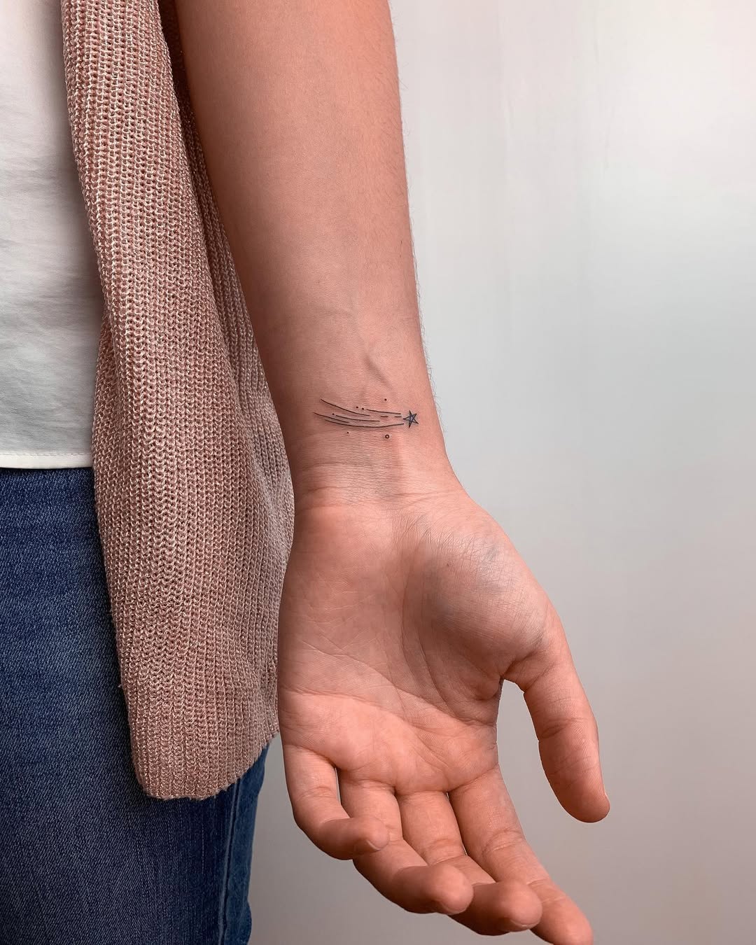 Minimalist star tattoo on wrist for subtle charm