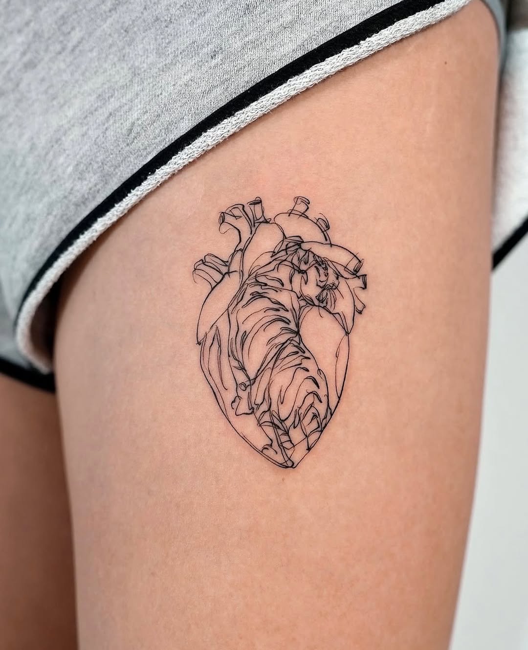 Elegant black line heart tattoo design.