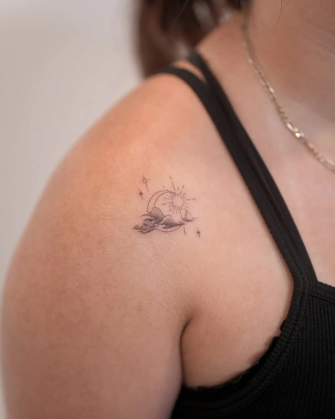 Delicate moon with sun and clouds tattoo