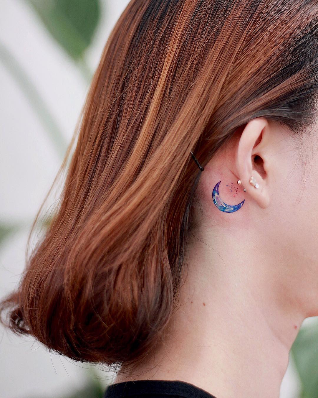 Elegant moon tattoo on neck area