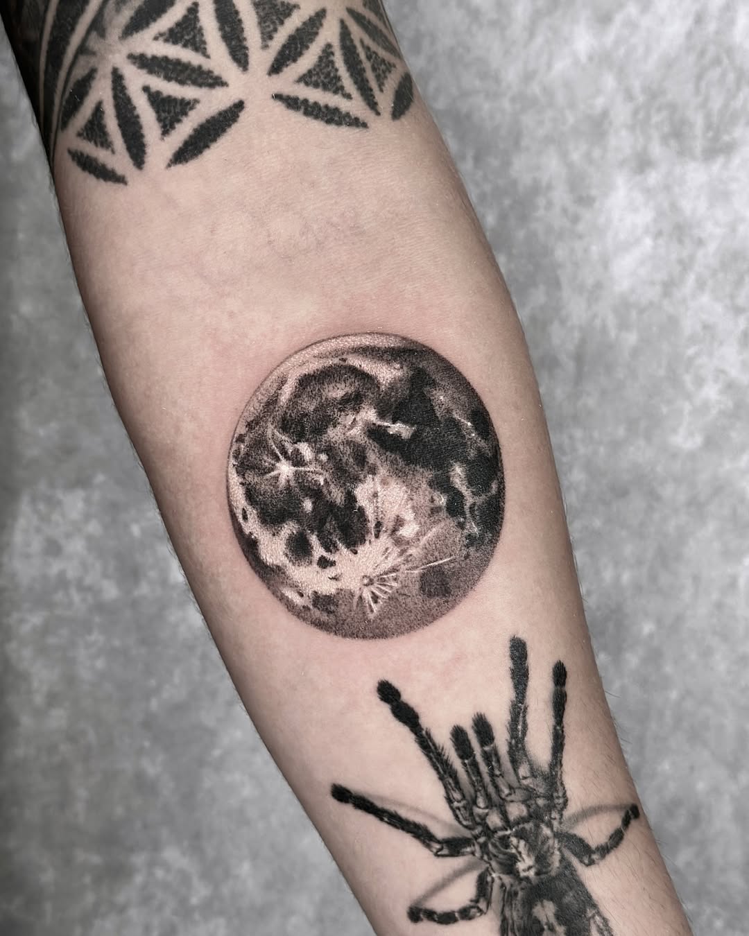 Stunning realistic moon tattoo on the forearm