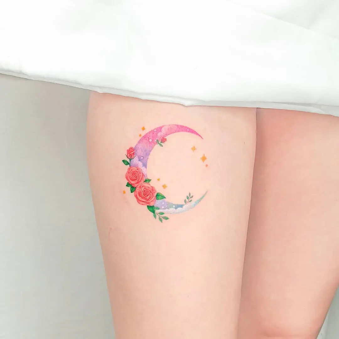 Colorful moon tattoo adorned with roses