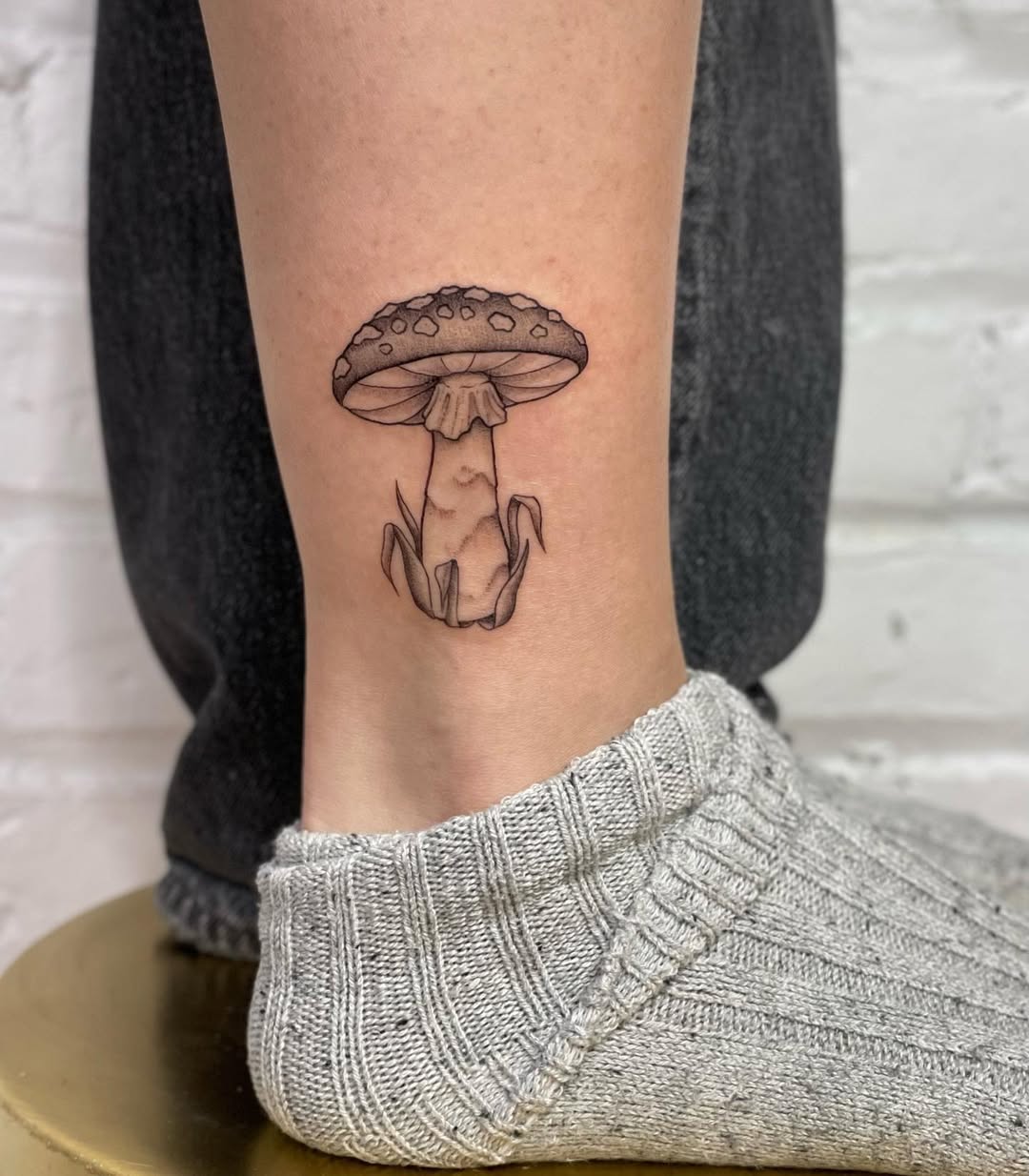 Charming mushroom tattoo gracing the ankle area