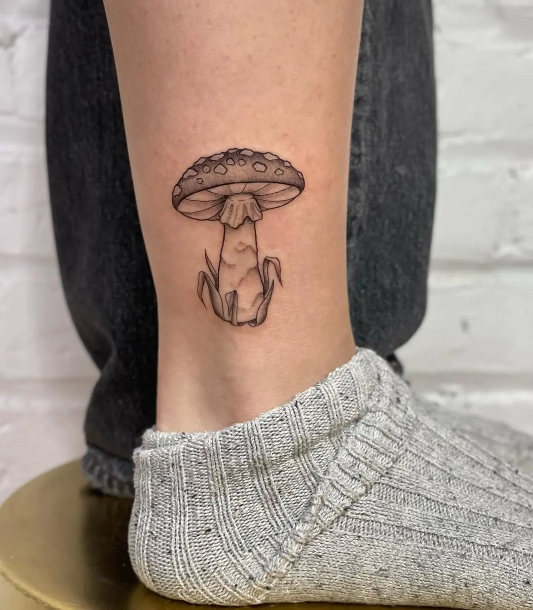 Charming mushroom tattoo gracing the ankle area