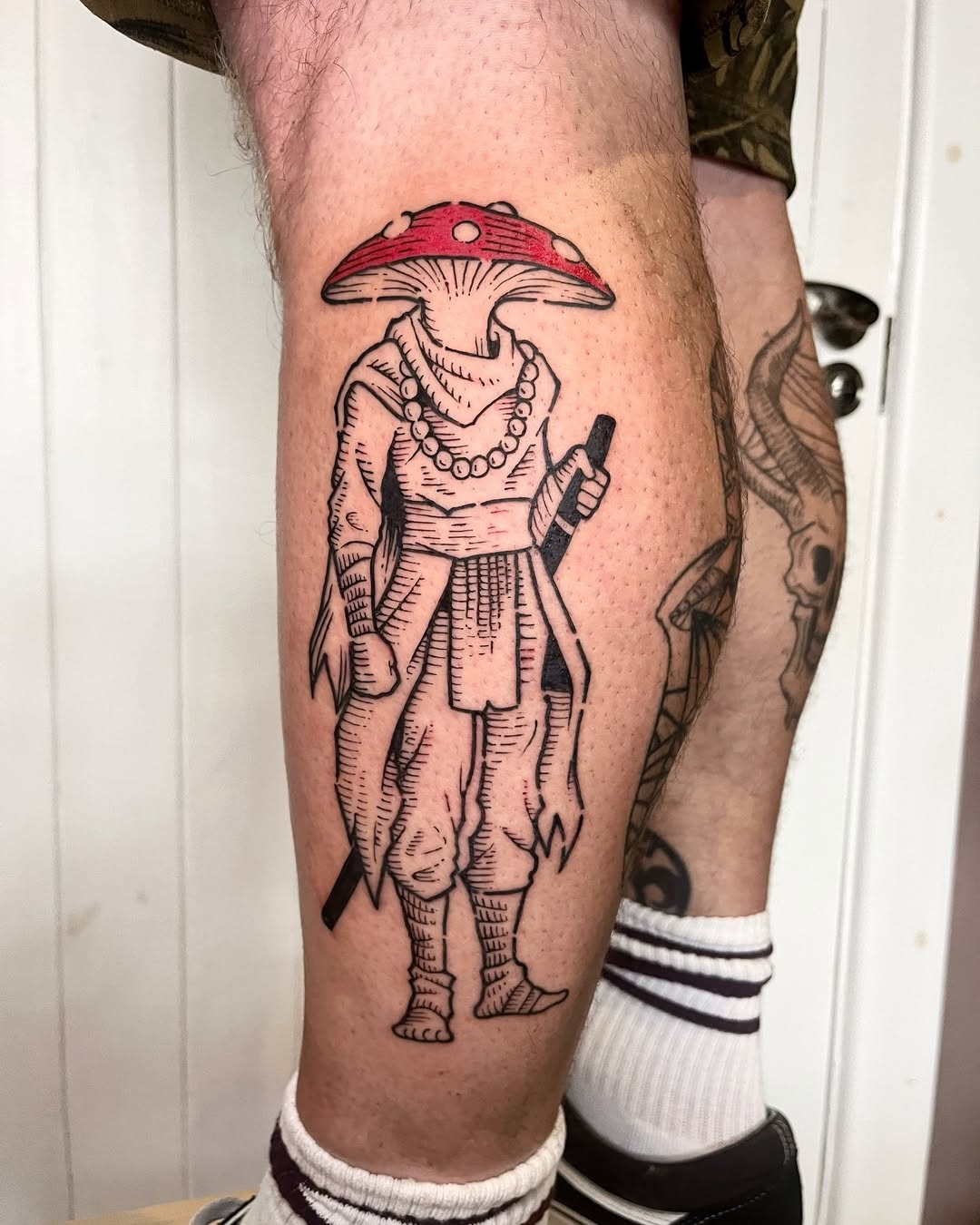 Mystical mushroom-inspired figure tattoo design