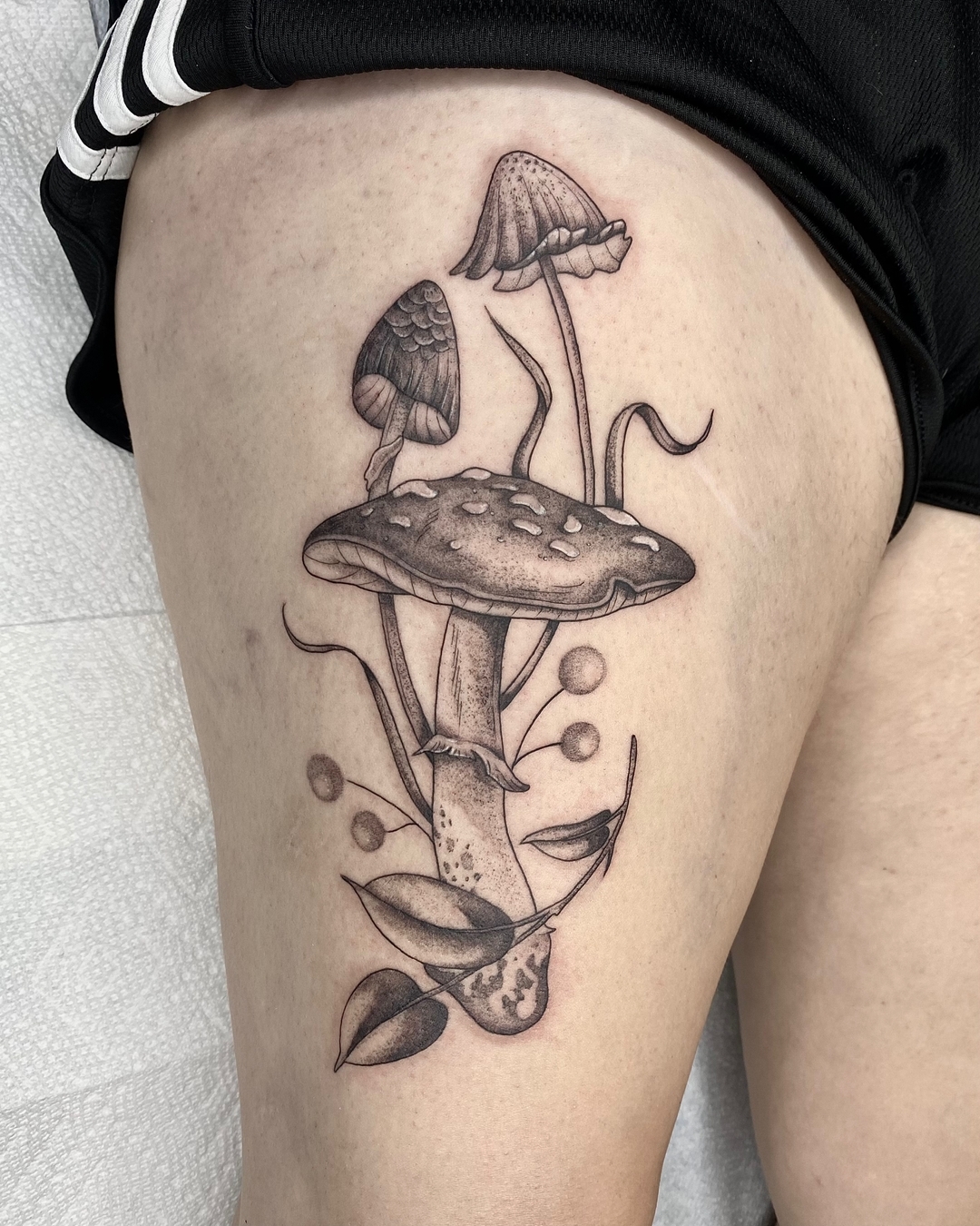 Stunning thigh mushroom tattoo with delicate details