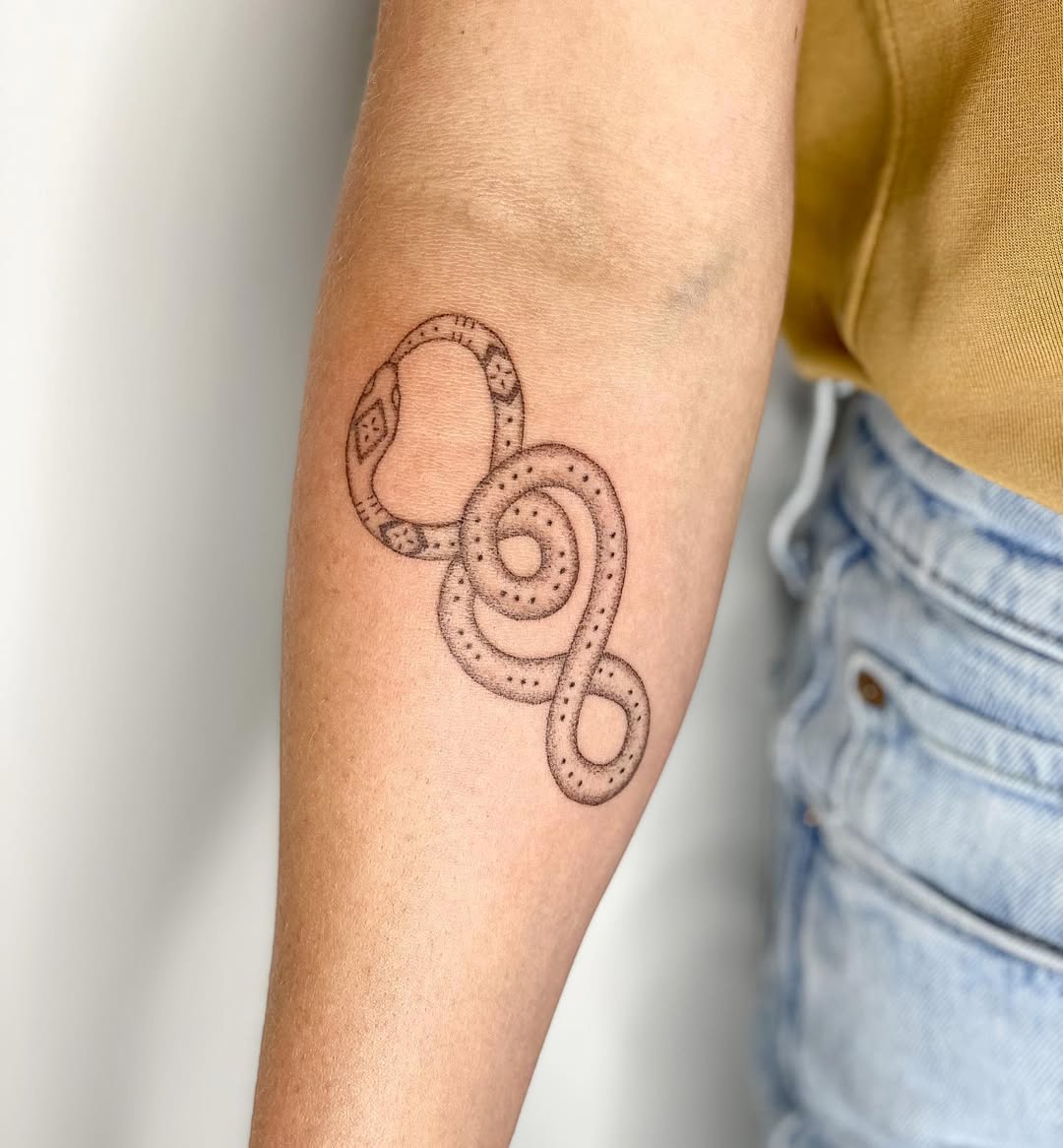 Unique ouroboros serpent tattoo on forearm