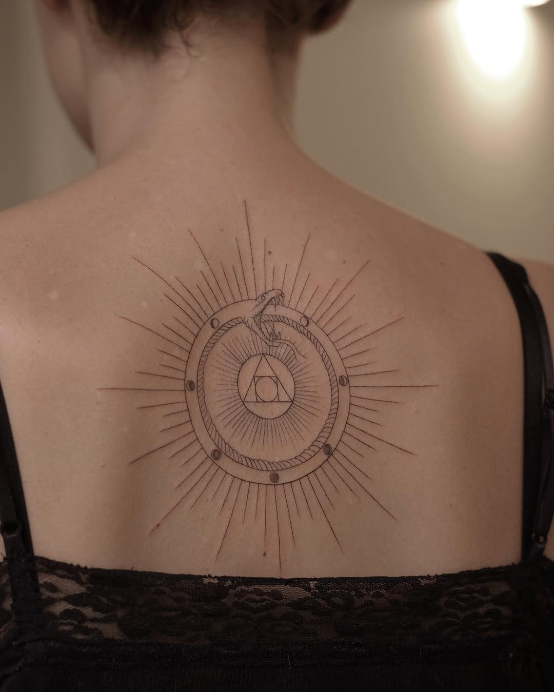 Stunning Ouroboros Design with Radiant Sun Rays