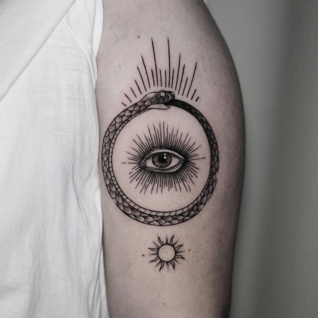 Stunning ouroboros design with sun and eye