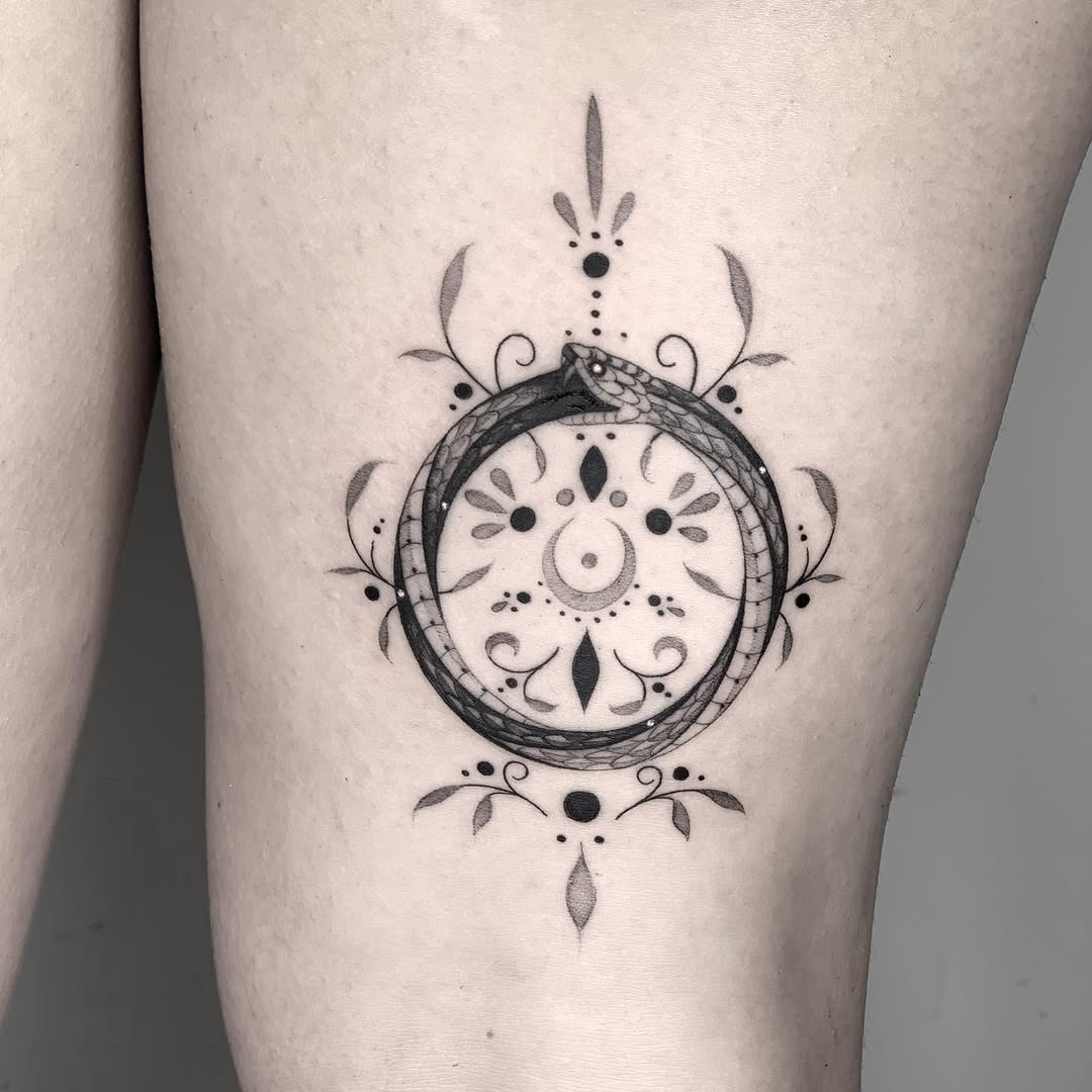 Elegant ouroboros tattoo with intricate designs