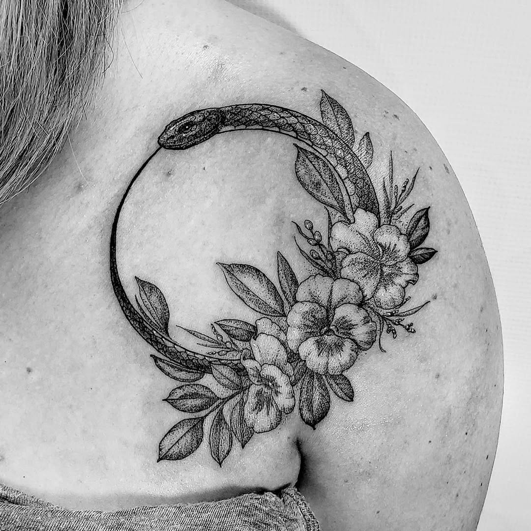 Elegant Ouroboros Tattoo with Floral Accents