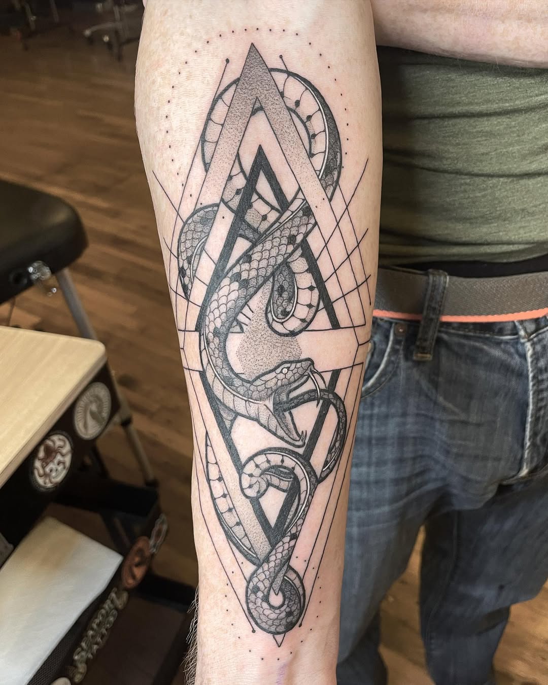 Intricate geometric ouroboros tattoo design