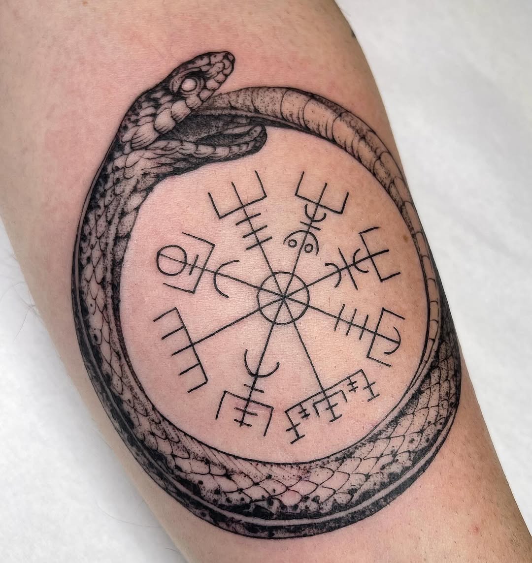 Intricate ouroboros tattoo with symbolic elements