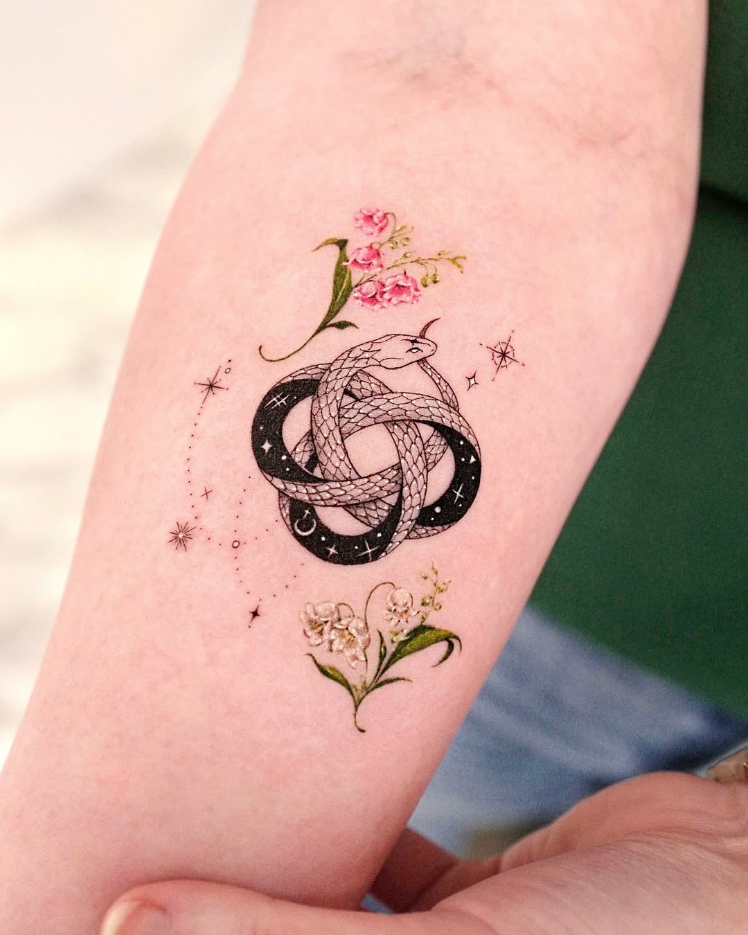 Intricate ouroboros tattoo with floral elements