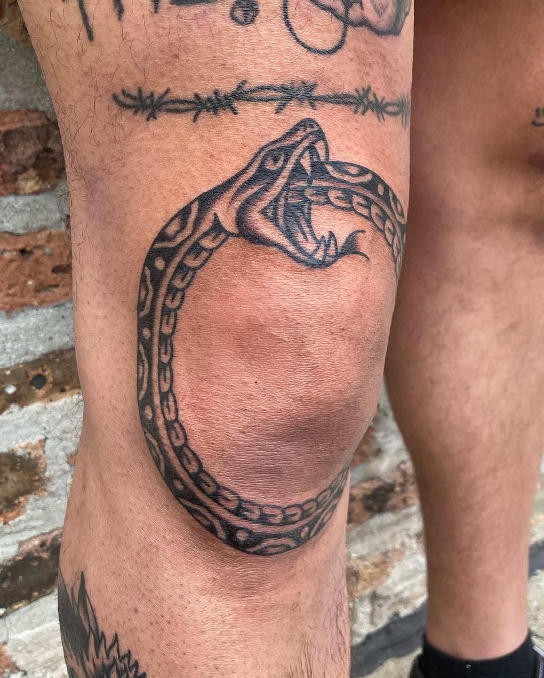 Fierce Ouroboros Snake Tattoo on Knee