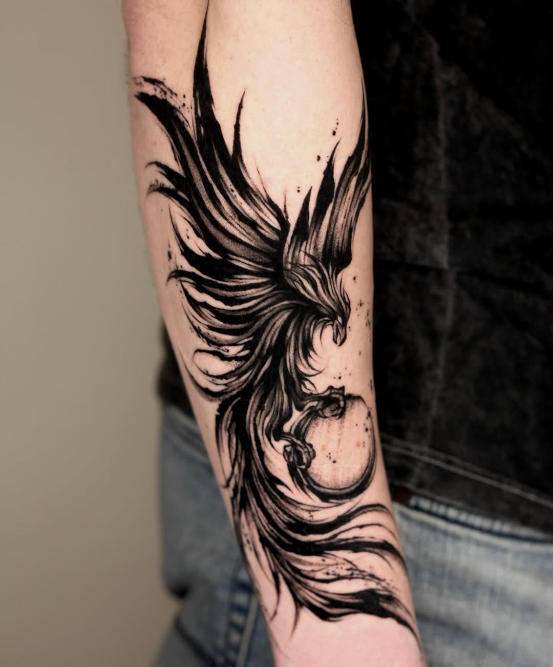 Intricate black ink phoenix tattoo design