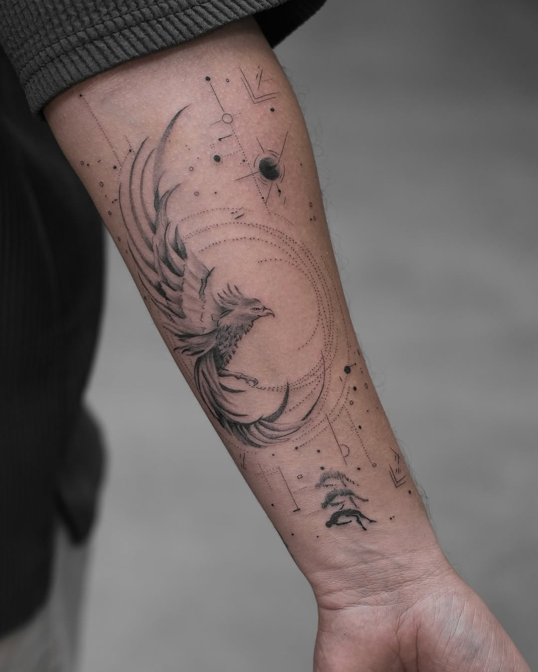 Stunning phoenix tattoo with cosmic elements