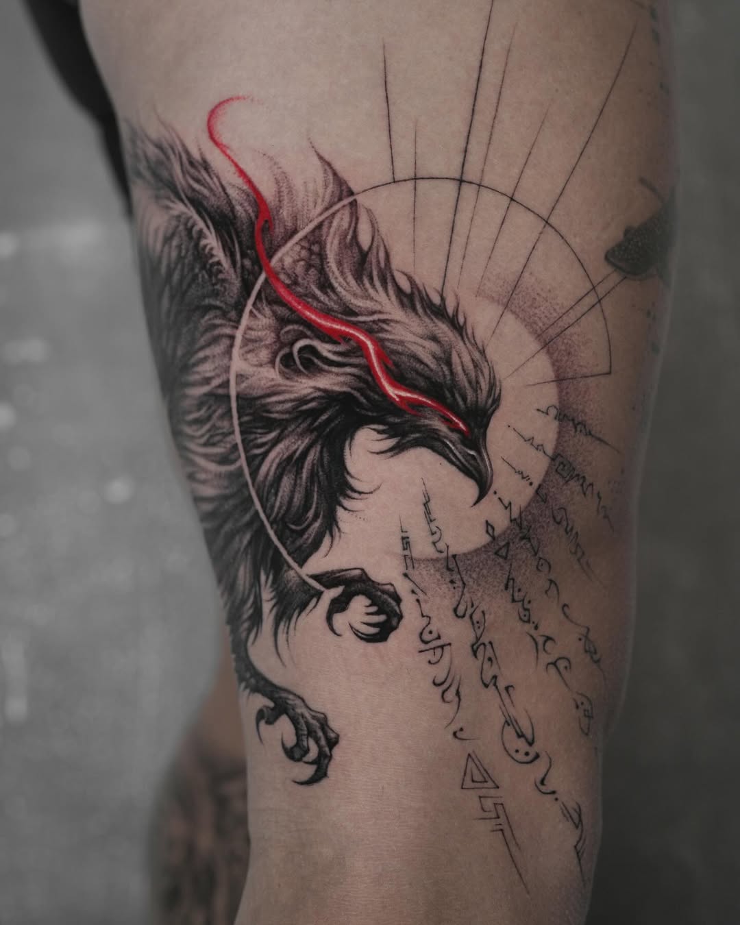 Bold phoenix tattoo with striking red details