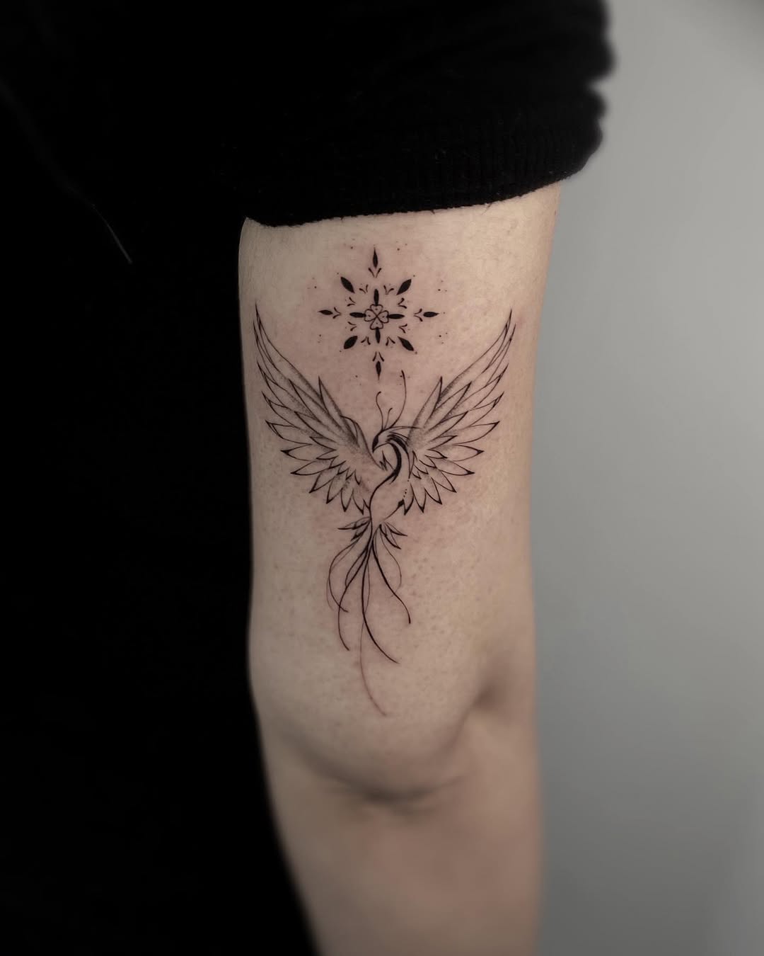 Elegant phoenix tattoo with graceful wings