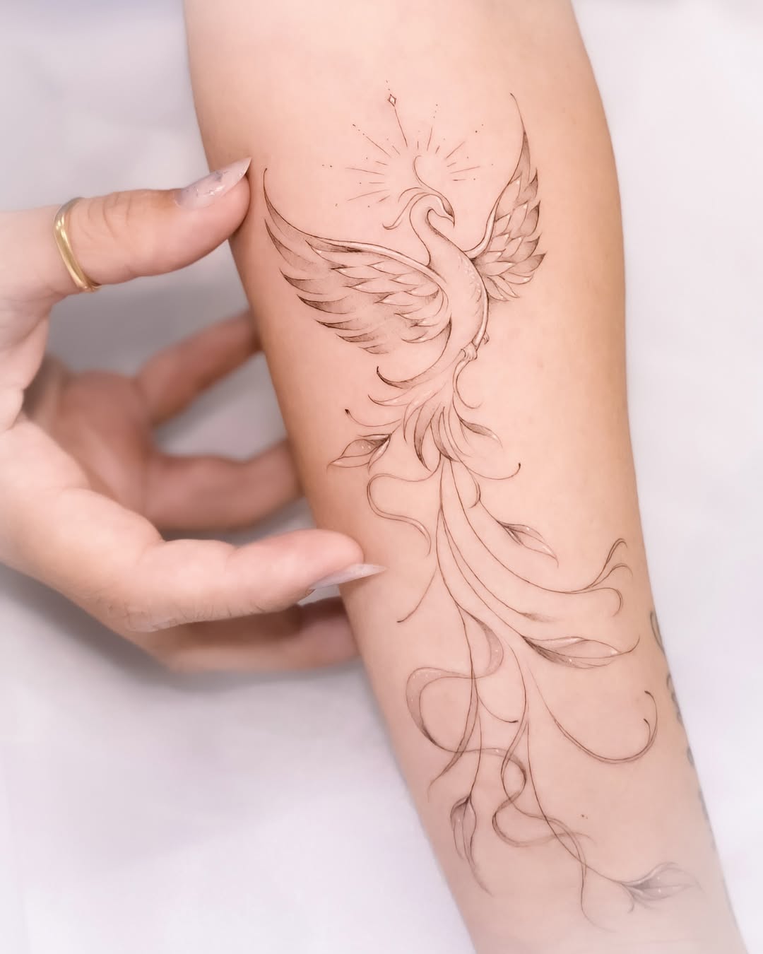 Elegant phoenix tattoo with flowing lines