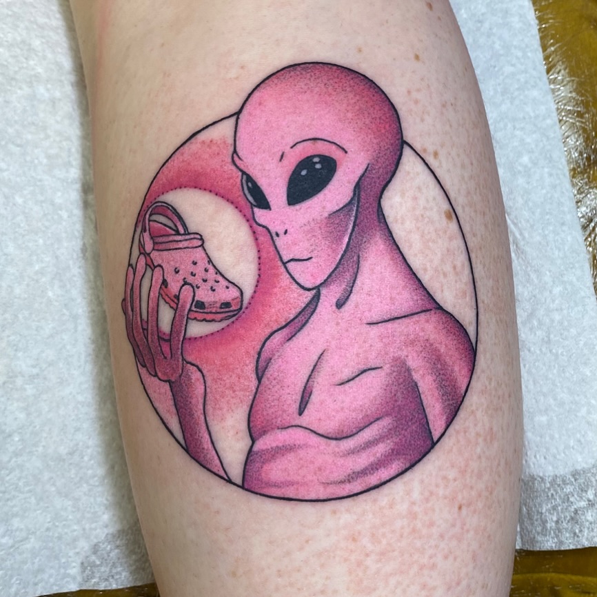 Quirky alien tattoo with a playful twist