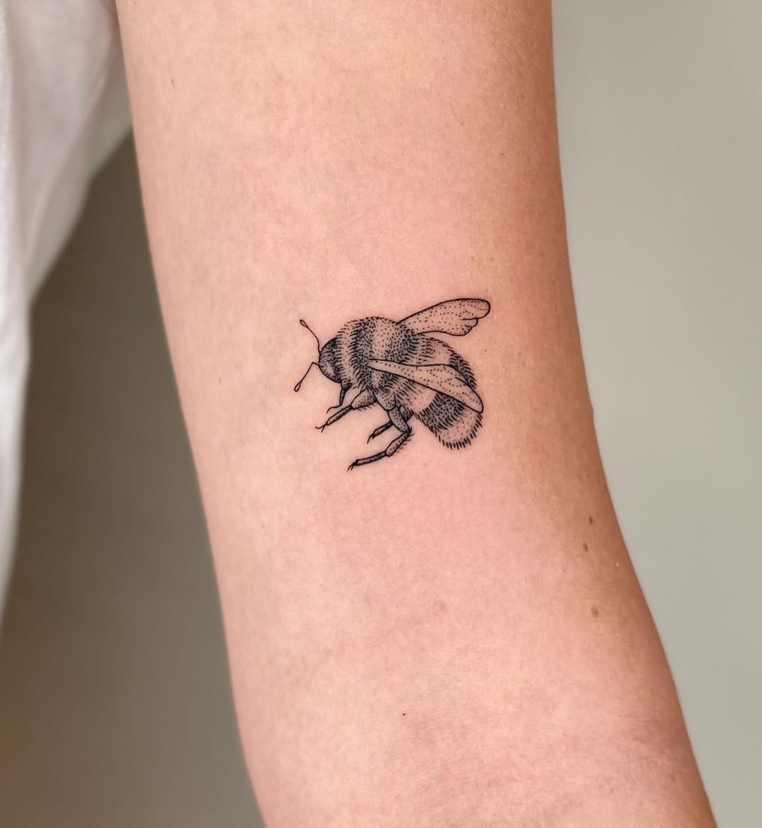 Stunning realistic bee tattoo on the arm