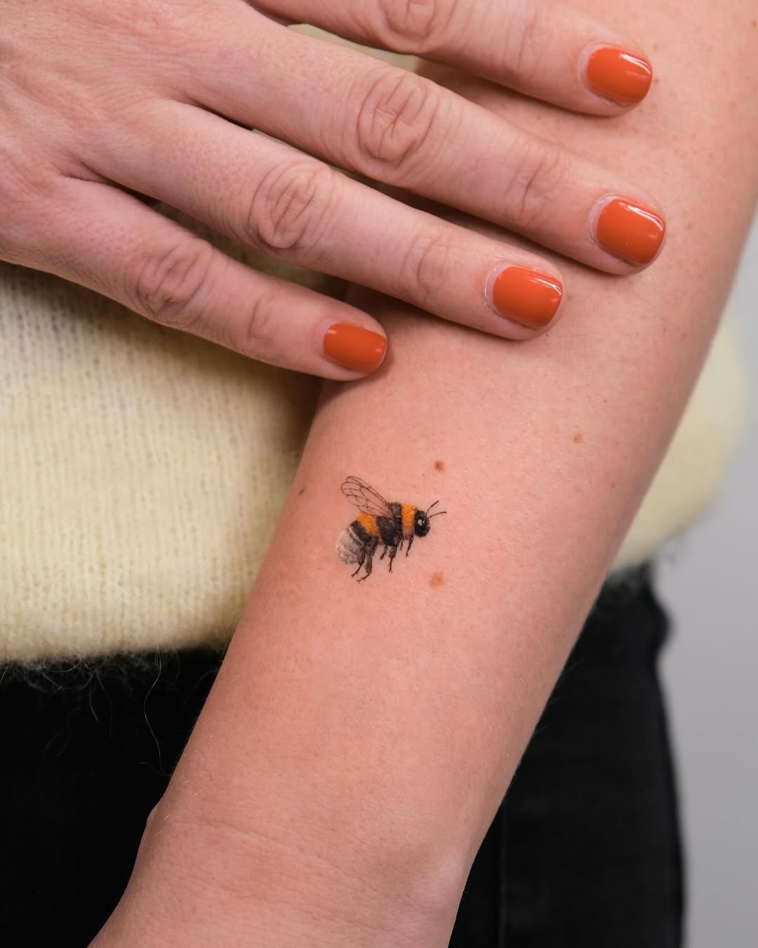 Elegant realistic bumblebee tattoo on arm