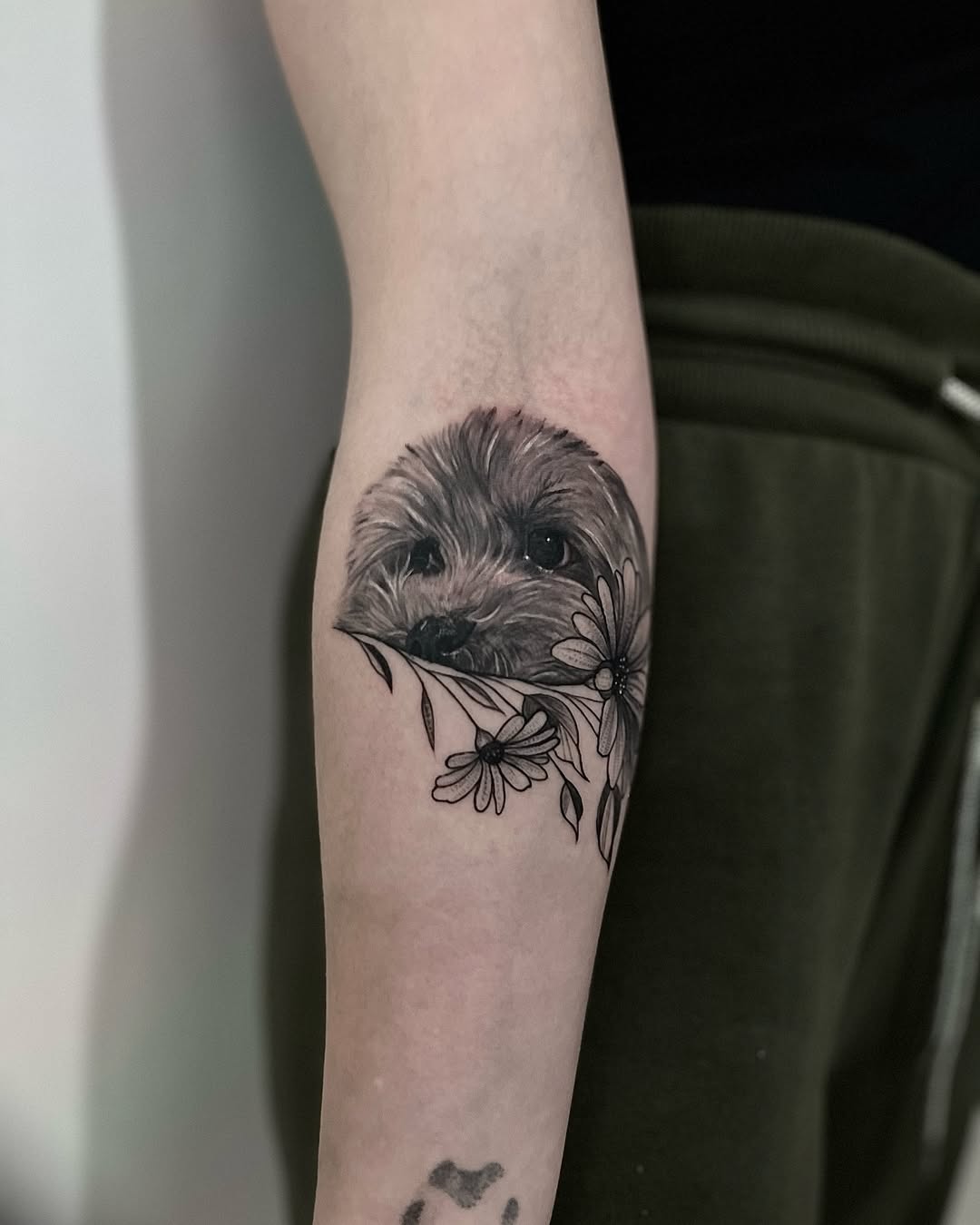 Charming dog tattoo with floral accents