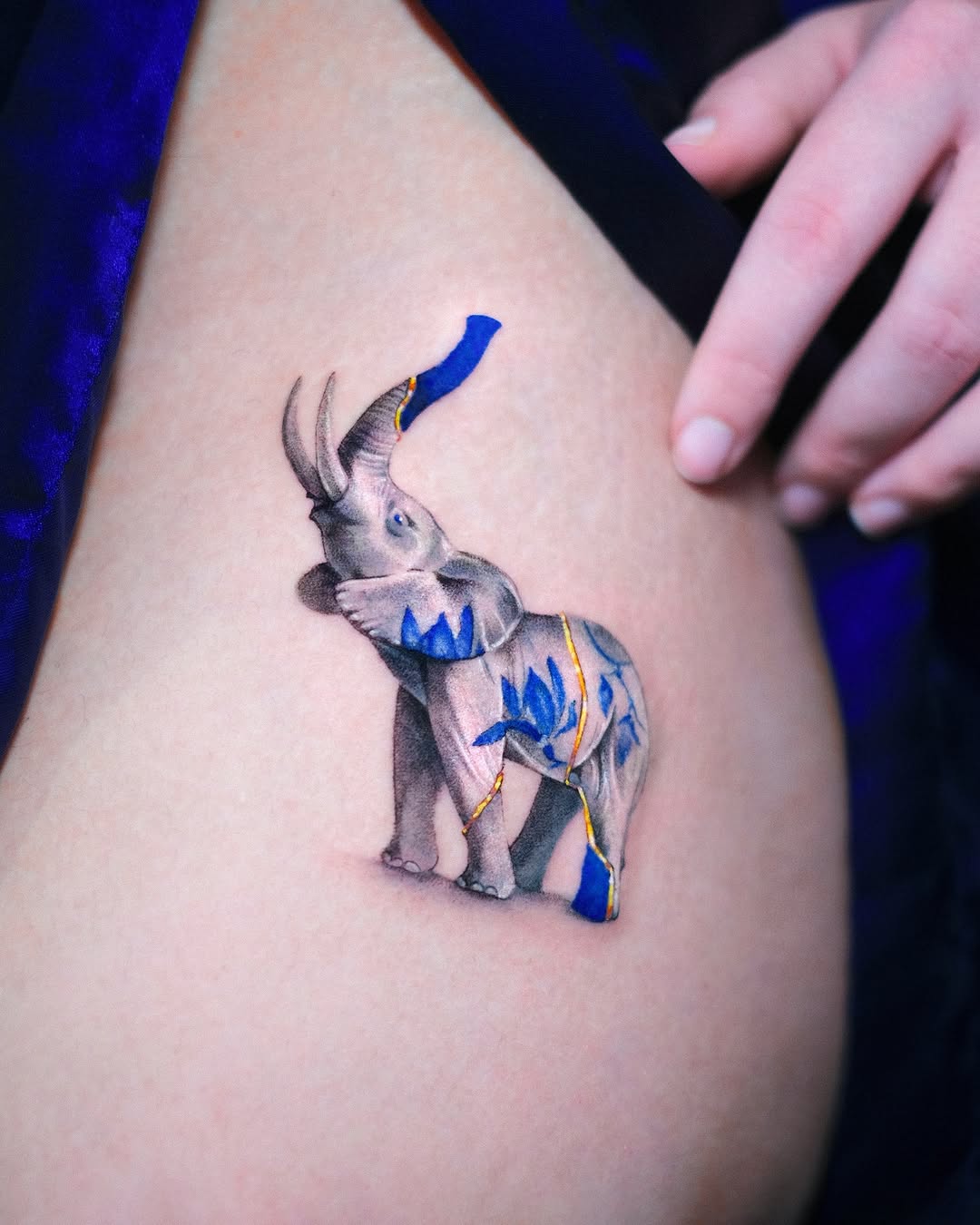 Stunning realistic elephant tattoo with blue accents