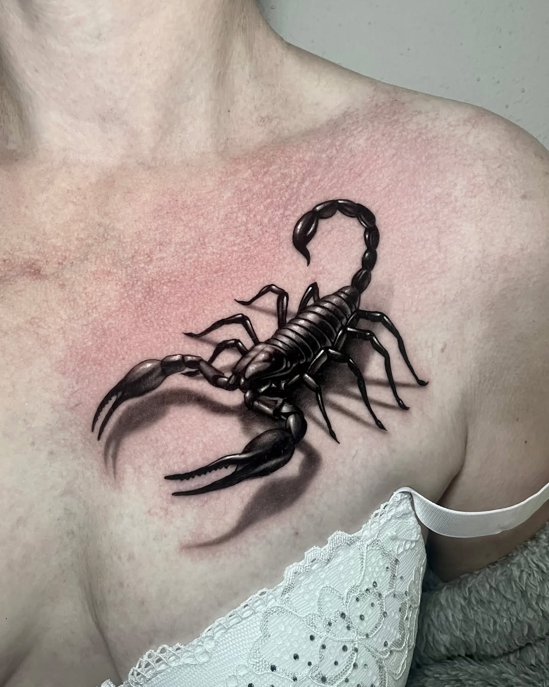 Bold scorpion tattoo on woman's chest