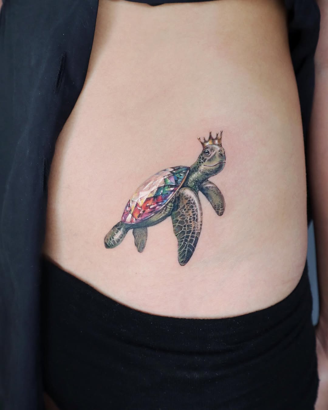 Regal turtle tattoo with gem for elegance