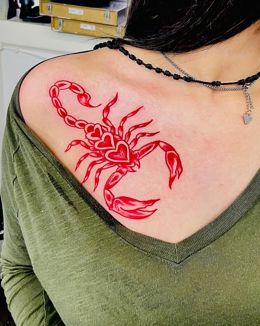 Bold red scorpion tattoo with heart details