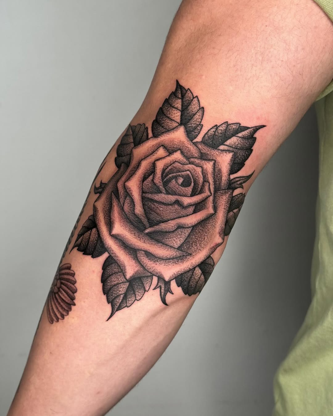 Bold Black Rose Tattoo on Elbow