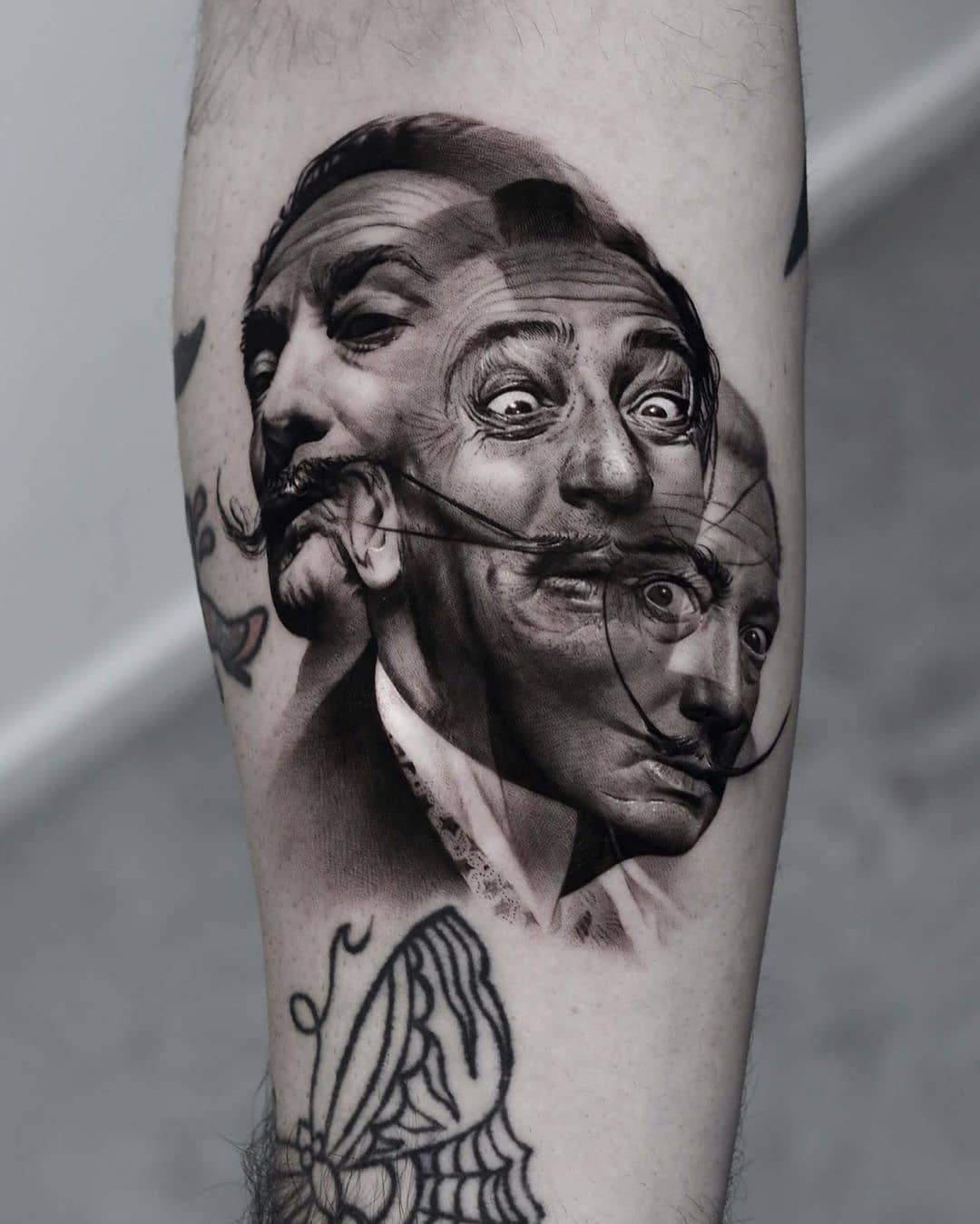 Intricate black and gray Dali portrait tattoo