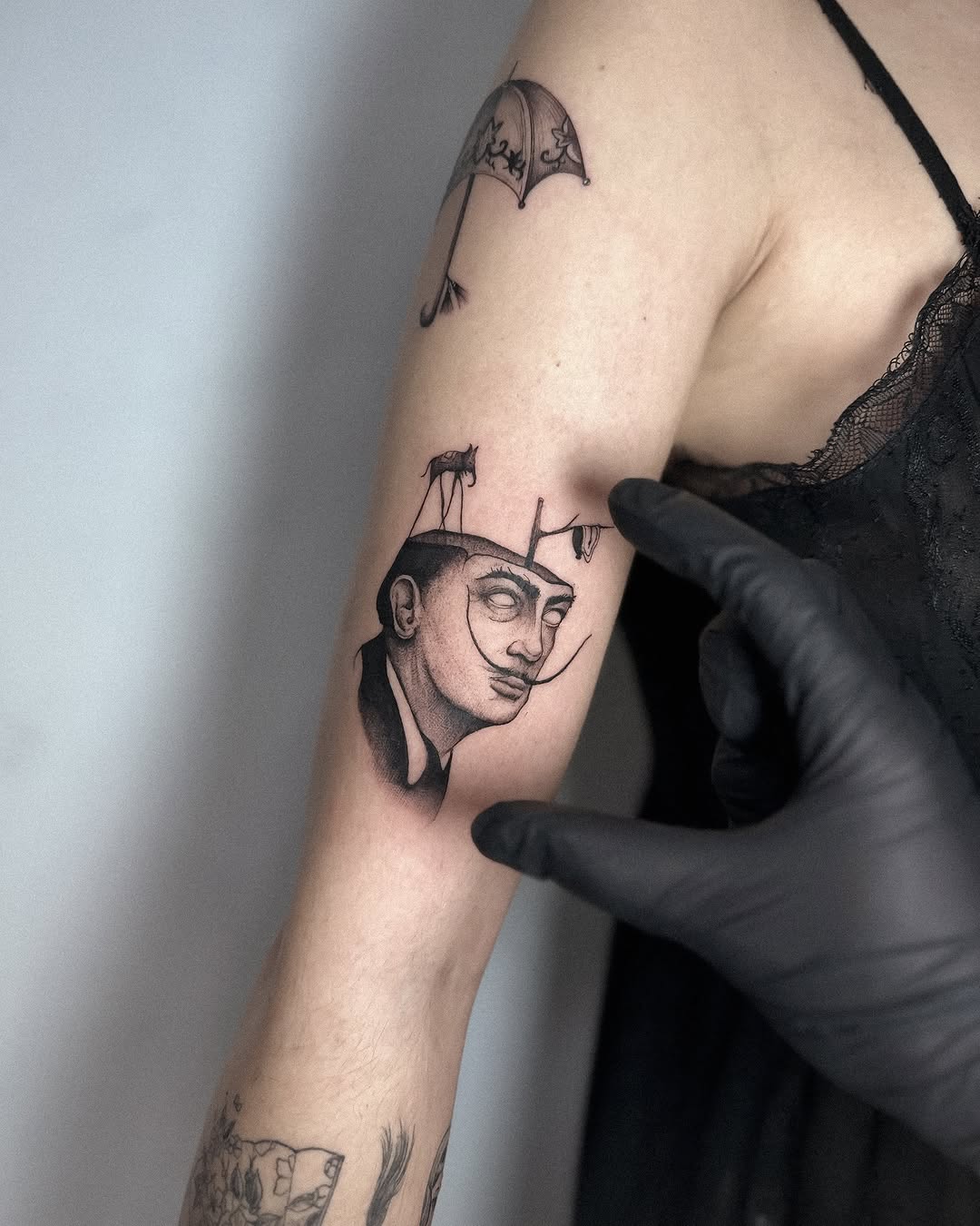 Whimsical Salvador Dali tattoo with surreal elements