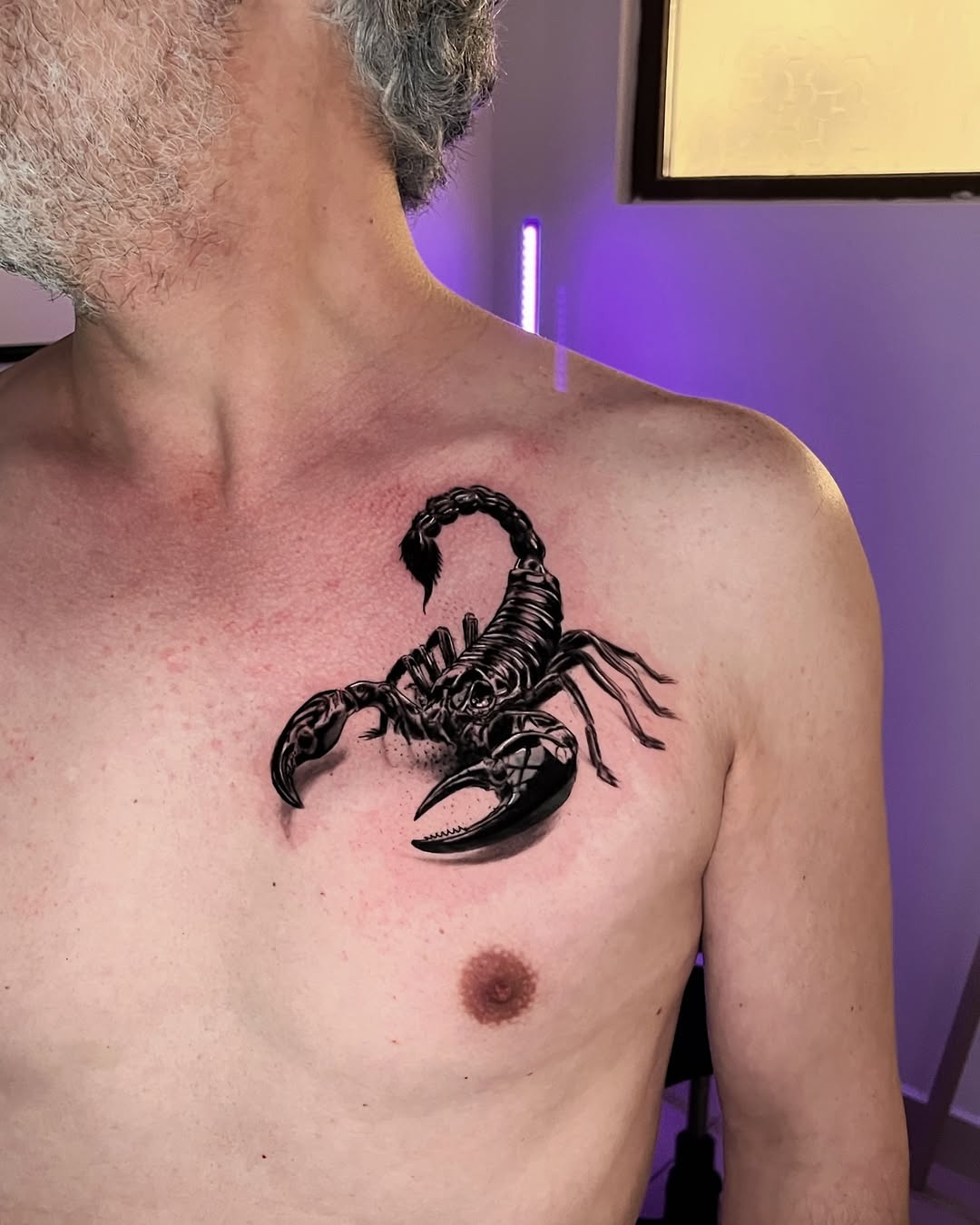 Bold scorpion tattoo on muscular chest