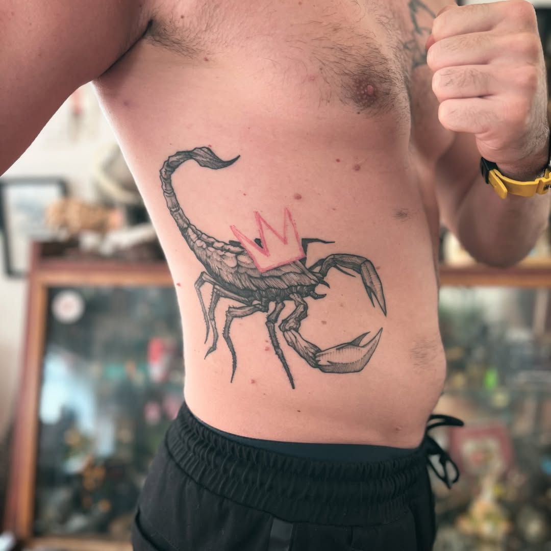 Stylish scorpion tattoo with a royal twist