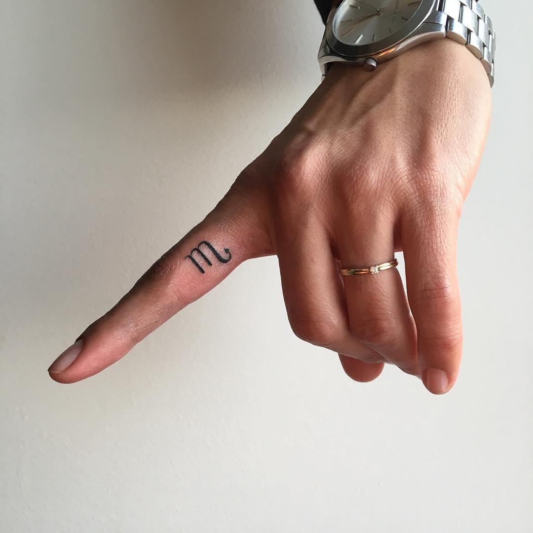 Minimalist scorpio tattoo on a finger