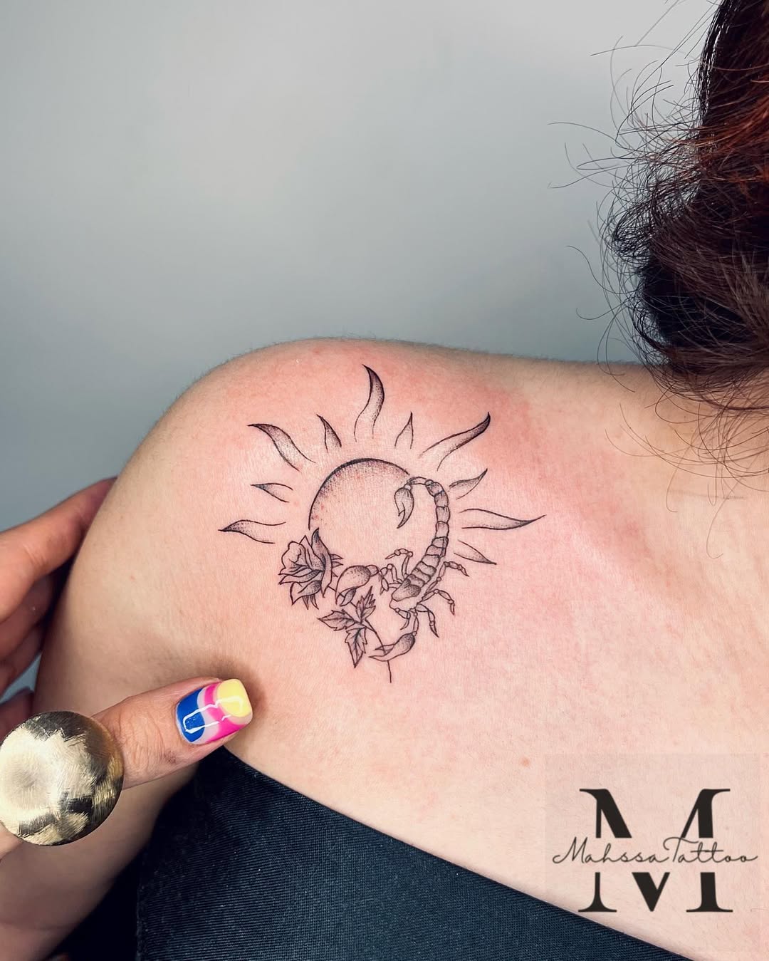 Stylish Scorpio tattoo with sun and flowers