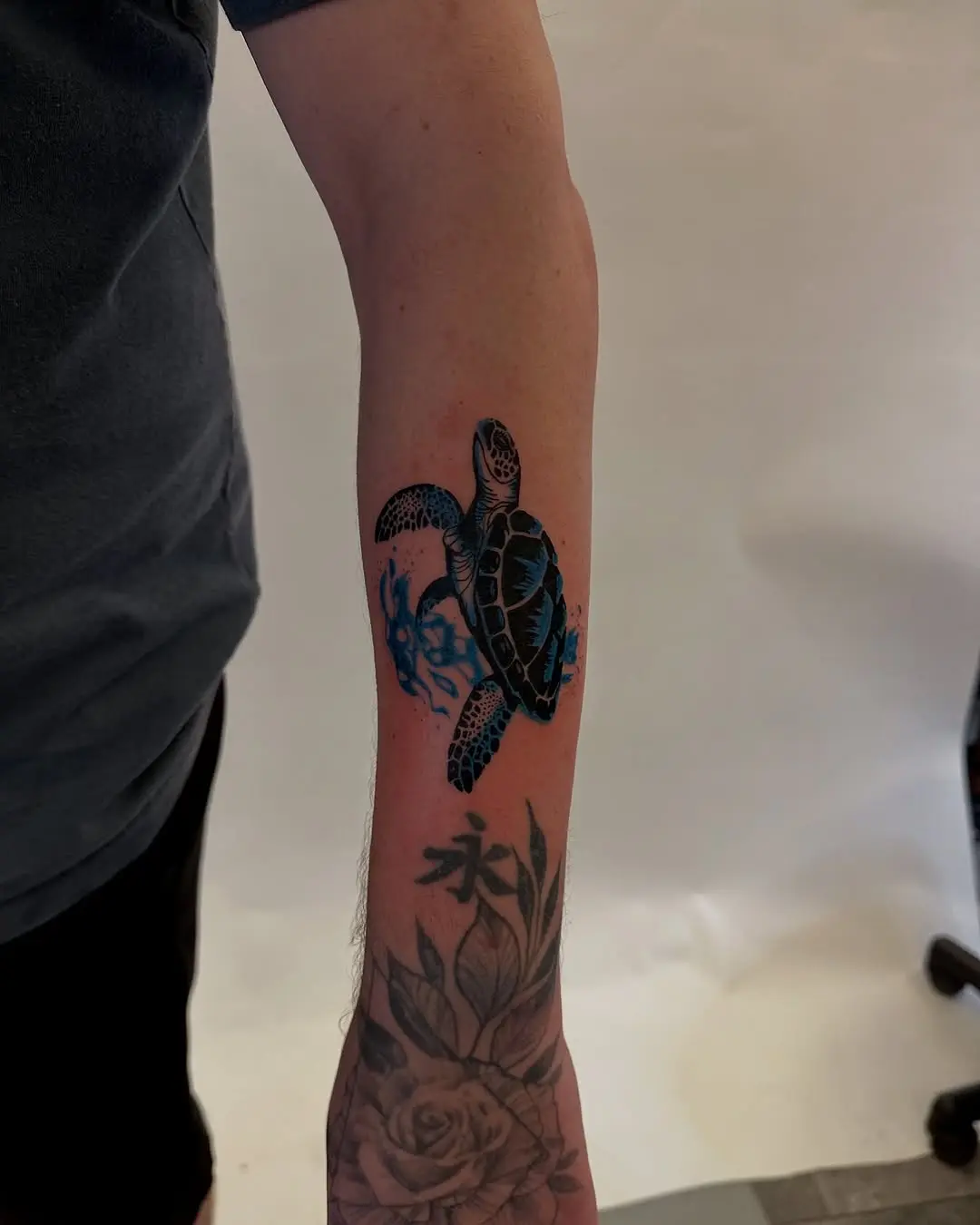 Vibrant turtle tattoo with blue ocean waves