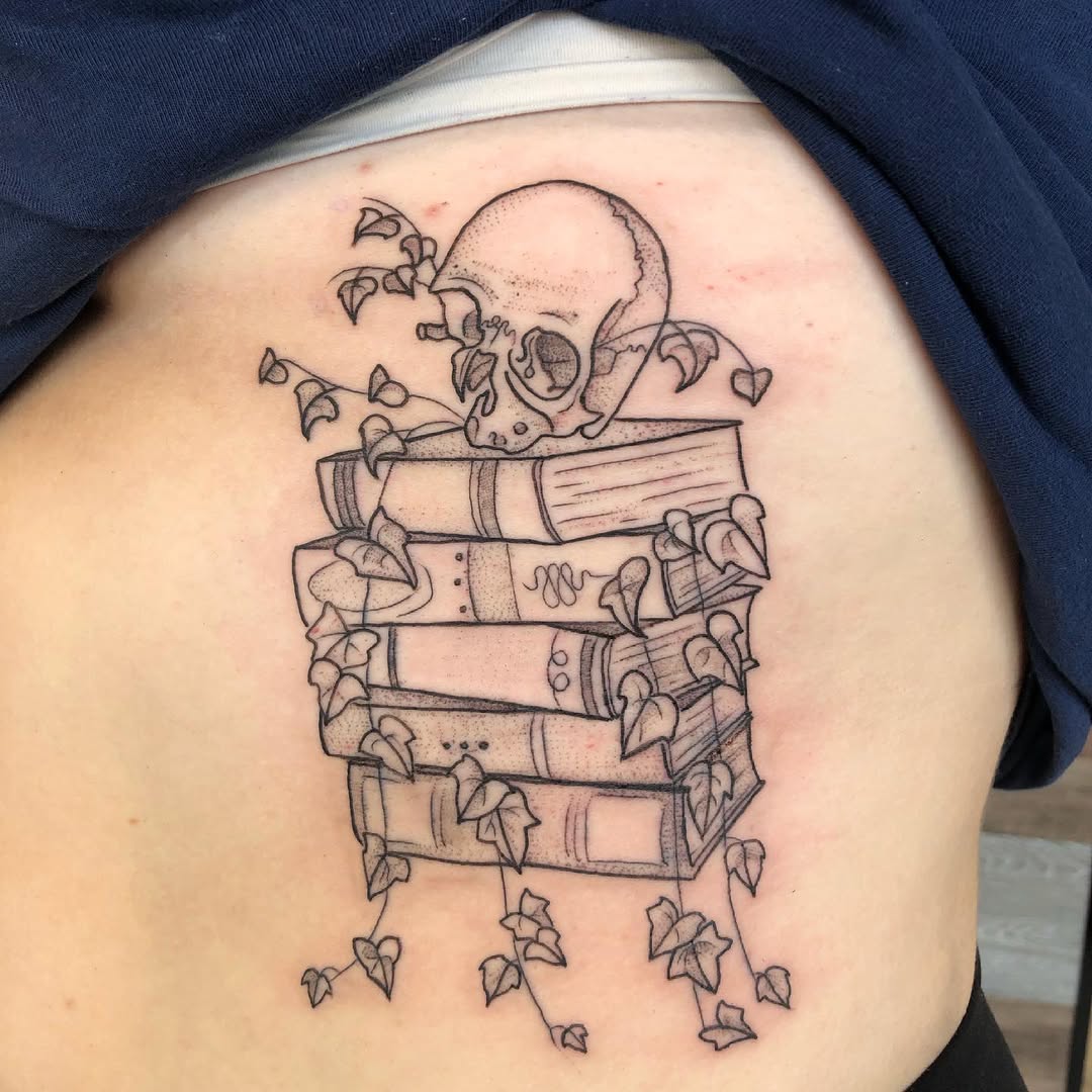 Intricate skull and books tattoo design