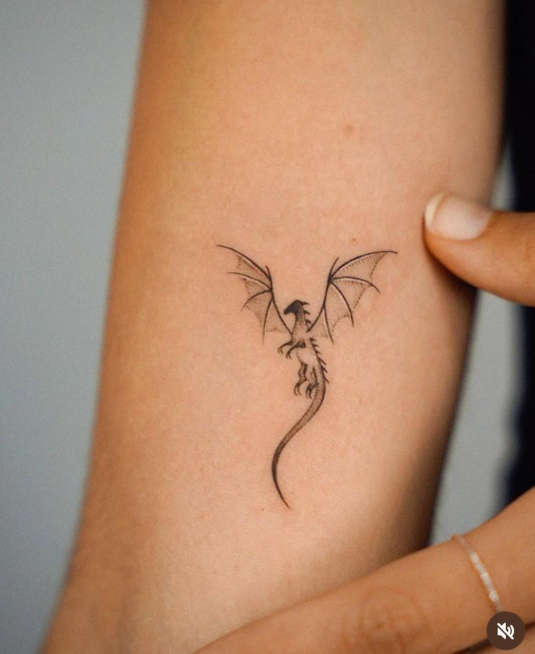 Minimalistic Dragon Tattoo with Delicate Wings