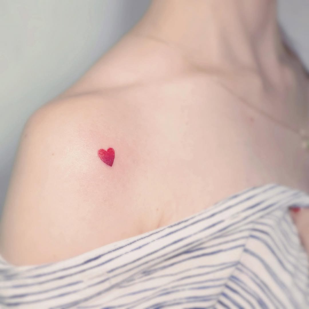 Delicate heart tattoo on shoulder