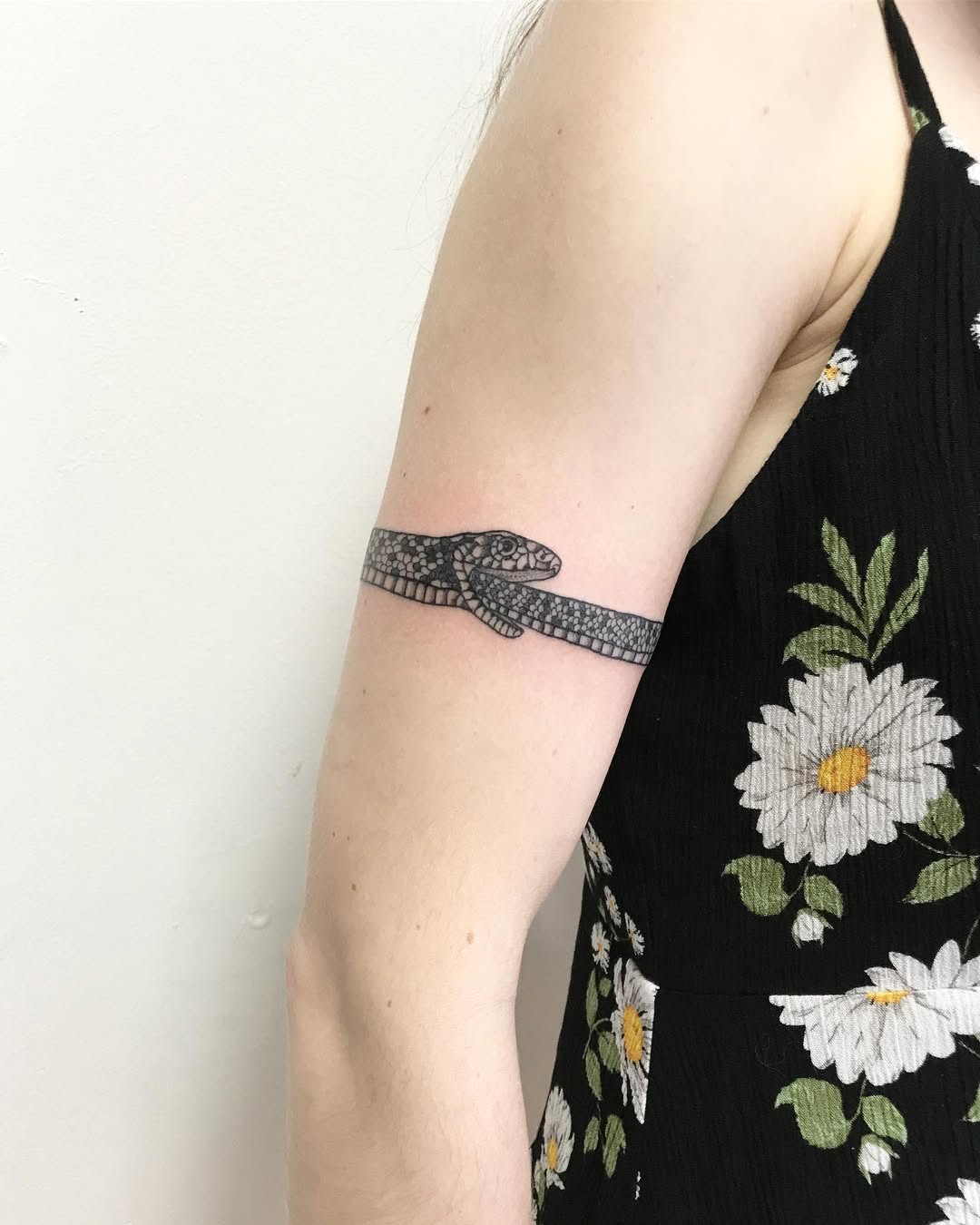 Elegant ouroboros tattoo with floral aesthetics