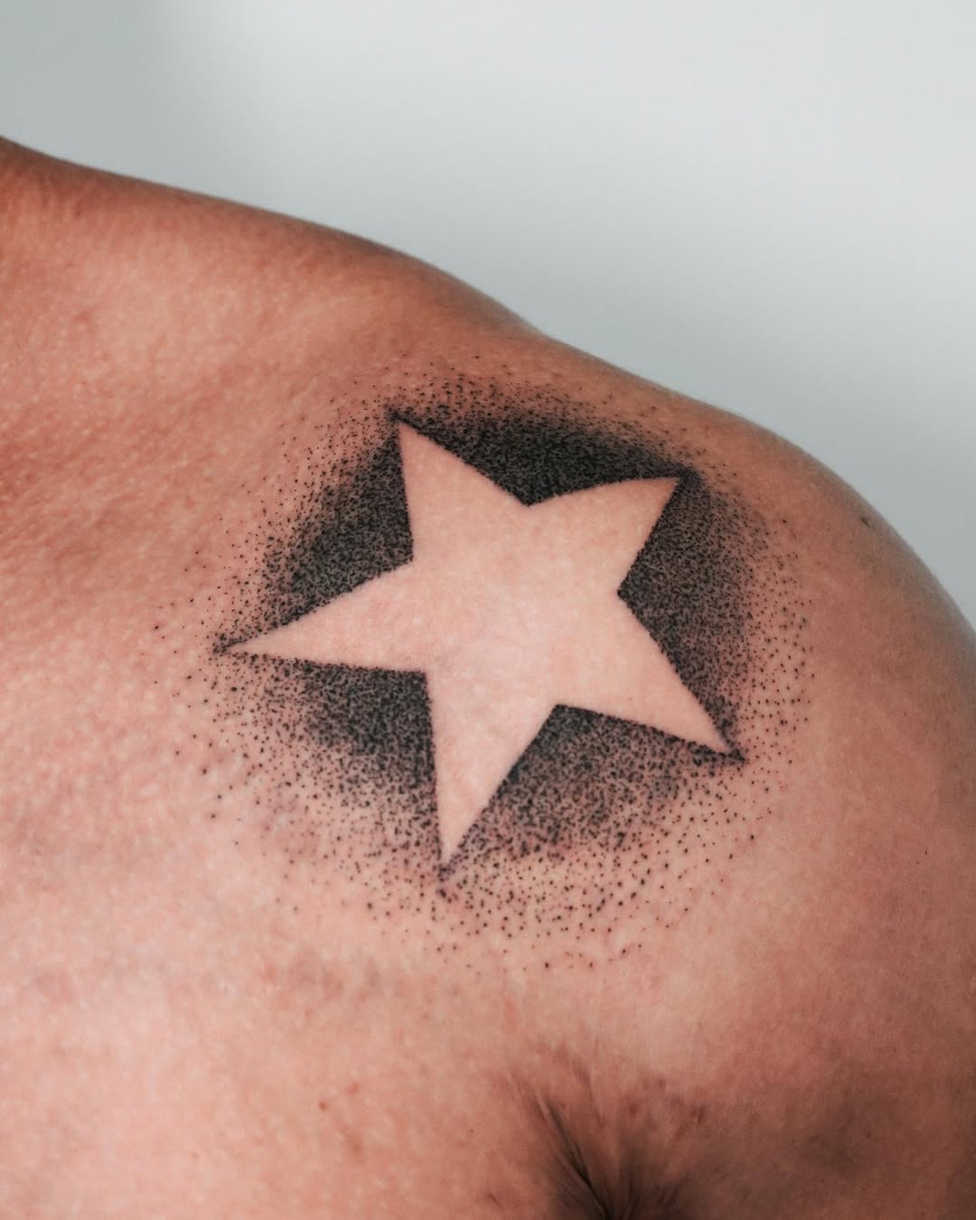 Striking star tattoo with dotted shading technique